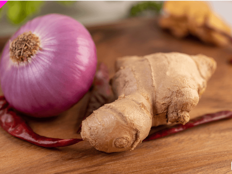Fresh red onions and peppers on a dark surface — heritage cooking ingredients