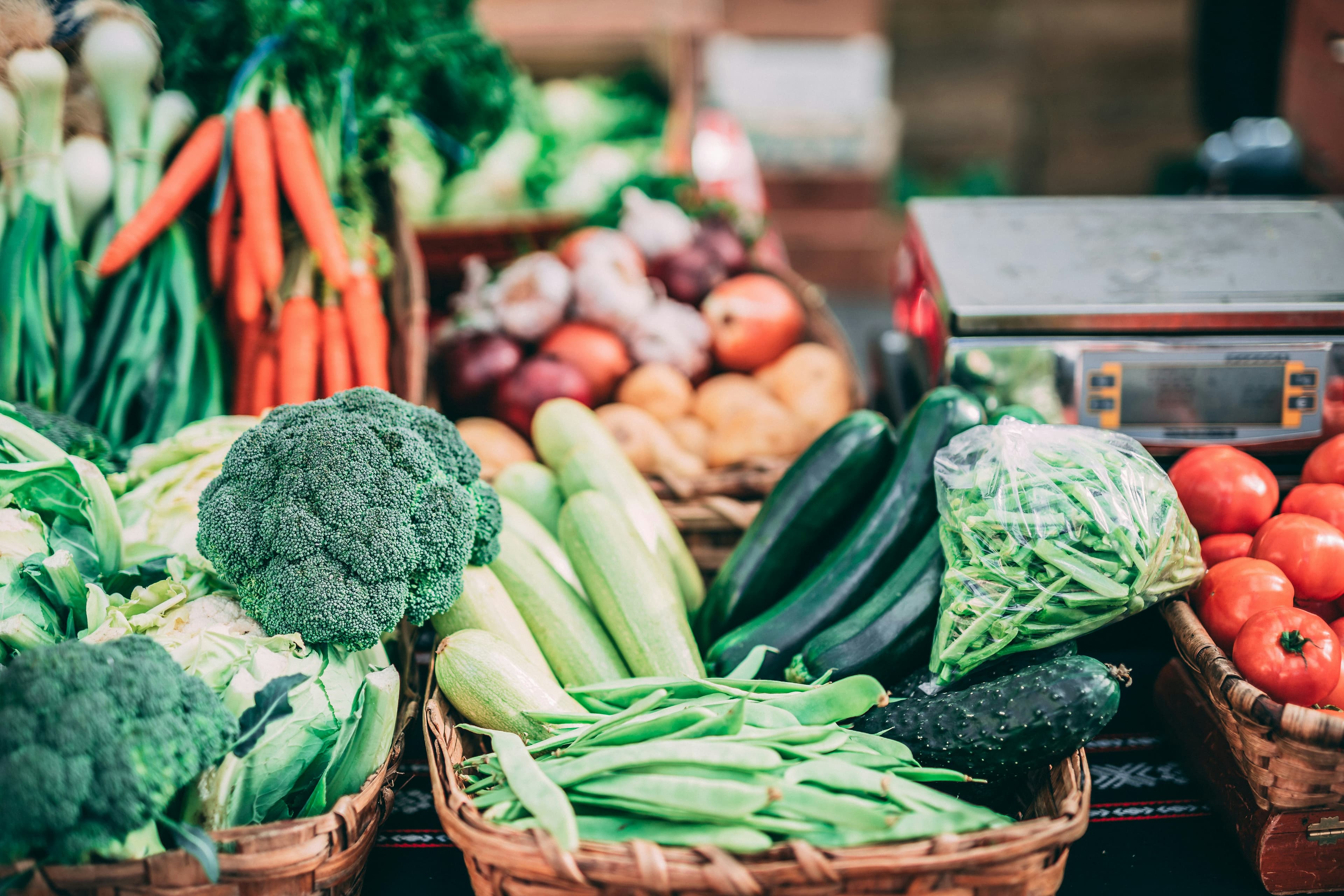 Fresh produce stall — broccoli, carrots, cucumbers, tomatoes and beans, the natural ingredients behind Ofe's recipes